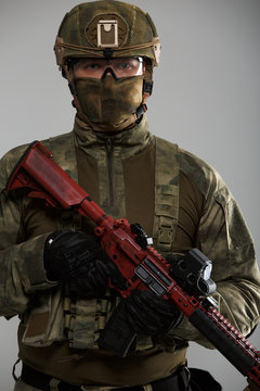 Image of military man in helmet with gun