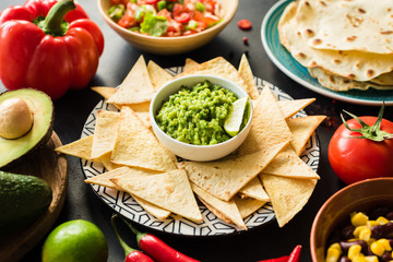 Mexican food Guacamole Nachos Tortilla chips salsa and beans