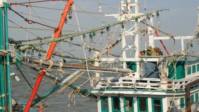 Lamps on boat that catches squid. Old wooden boat on the dock