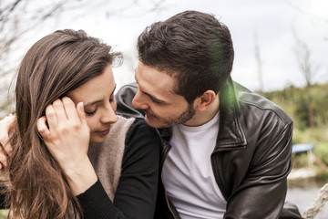 nice couple of boyfriends embraces and kisses