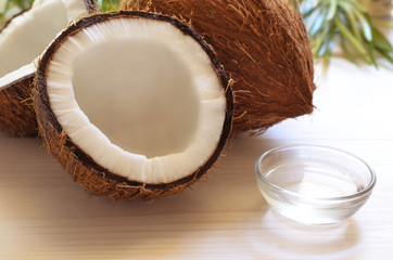 Coconut and coconut oil on wooden background.