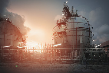 Gas storage spheres tank in oil refinery plant on sky sunrise background