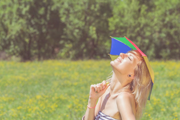 Fototapeta na wymiar LGBT discrimination - girl posing with a multicolored umbrella in nature.