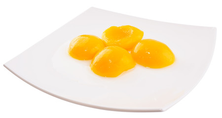 Apricot halves on plate isolated