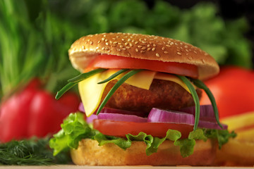 Close-up of home made tasty burgers on wooden table.Shallow depth of field
