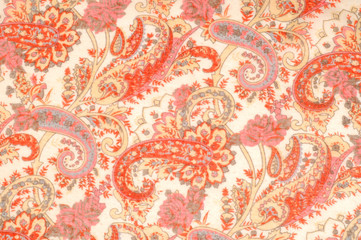 Texture, pattern, background. Silk fabric - paisley on a beige background. This beautiful silk...
