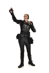 full length portrait of female  soldier wearing black  tactical armour  holding  a pair of binoculars, isolated on white studio background.