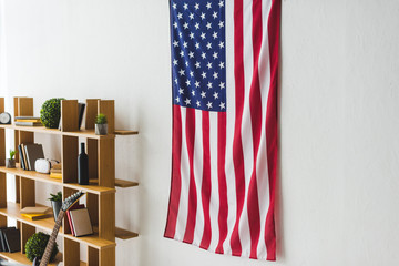 American flag hanging on wall inside living room - Powered by Adobe