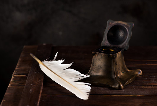 Ancient Inkwell and feather pen