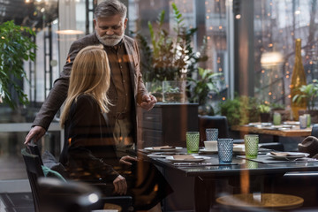 selective focus of senior man and woman on romantic date in restaurant