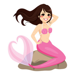 Beautiful mermaid girl sitting on stone with heart shape tail and long hair