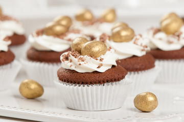 Easter Cupcakes Decorated With Golden Chocolate Eggs. Home Baked.