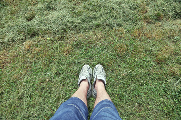 Grass texture with man in sneakers