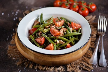 Warm salad of green beans, cherry tomatoes with fried bacon and parmesan cheese.