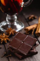 Chopped bitter chocolate with glass of mulled wine and spices
