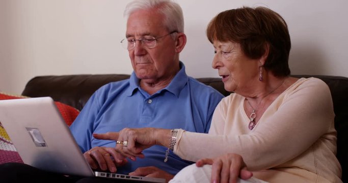 4k, A senior couple shopping online using laptop