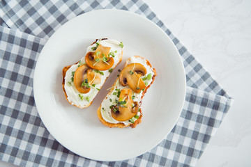 toast with cream cheese fried mushrooms and sprout top view
