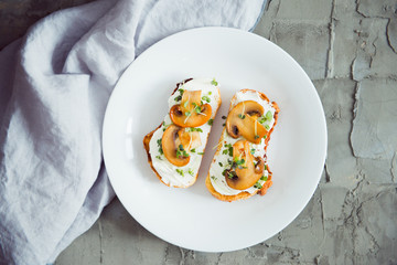 toast with cream cheese fried mushrooms and sprout top view