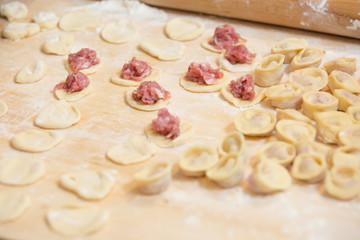 Dough made for modeling homemade ravioli, pelmeni or dumplings . Traditional Russian dish, national cuisine. Home cooking, handmade.