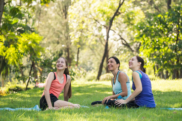 Naklejka premium Activities in the family, mother and daughter relaxing in the park after practicing yoga.