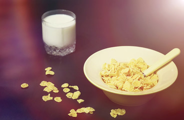 Corn flakes in a plate. Breakfast from flakes with honey and mil
