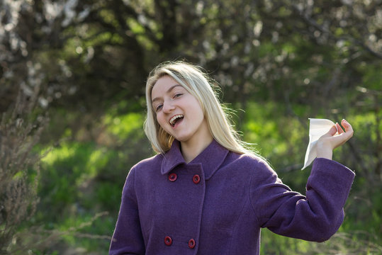happy healthy young woman throws out a handkerchief