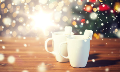 cups of hot chocolate with marshmallow on wood