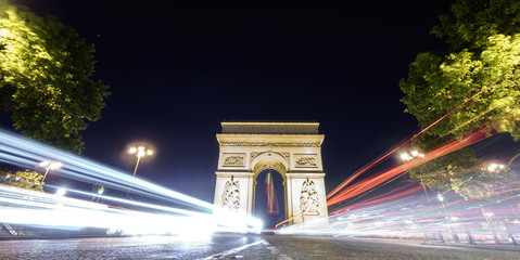 Fototapeta na wymiar Arc de Triomphe and car lights at night