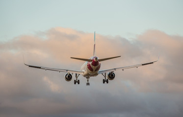 Commercial airplane flying above clouds.