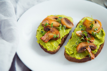 toast avocado and fried mushrooms with bean sprouts