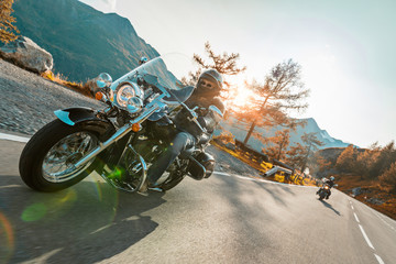Motorcycle driver riding japanese high power cruiser in Alpine highway on famous Hochalpenstrasse,...
