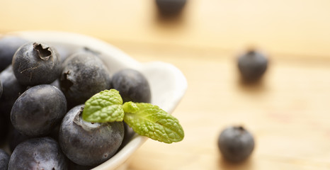 Fototapeta na wymiar fresh and raw blueberries and raspberries on wooden background