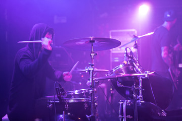Obraz premium Rocker drummer is playing on stage.