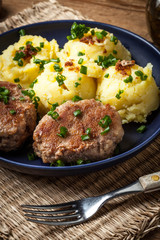 Meatballs served with boiled potatoes.