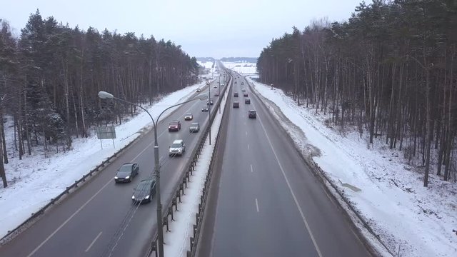 Drone view car moving on winter highway on background snow forest