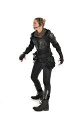 Fototapeta premium full length portrait of female soldier wearing black tactical armour, isolated on white studio background.
