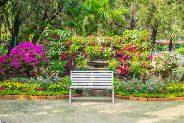 White chair in cozy flower garden./ White chair in cozy flower garden on summer.
