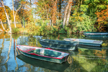 Old vintage colorful boats on the lake of Enghien les Bains near Paris, France