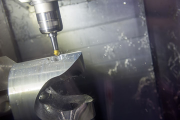 The 5 axis CNC machine cutting the automotive part with the solid ball end mill.