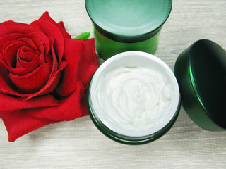 cosmetic cream for face care and rose flowers
