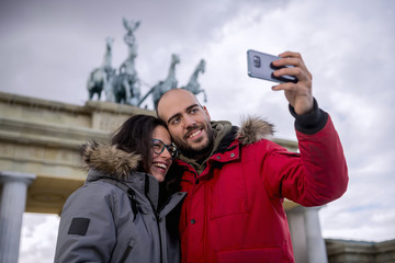 Couple taking a picture at the Brandenburg Gate