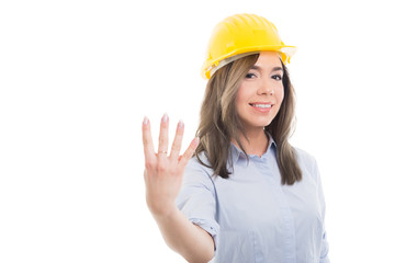 Portrait of female constructor showing number four.