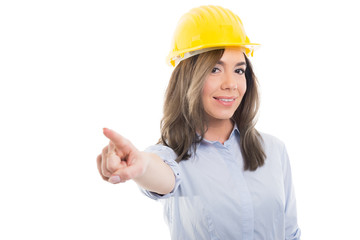 Portrait of female constructor pointing camera.