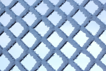 metal rhombuses in the frost fence texture