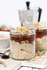 sweet oat pudding with jam and bananas, vertical closeup