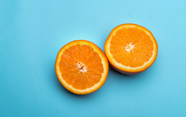 Halves of orange on blue background