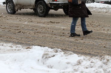 Winter. People walk on a very snowy sidewalk and road. People step on an icy pathway, icy sidewalk....