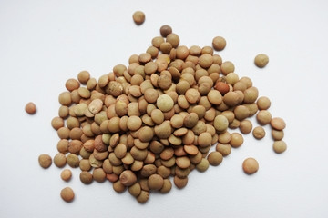 Close up of a pile of raw lentils, isolated  on white background
