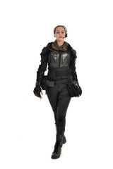 full length portrait of female  soldier wearing black  tactical armour, isolated on white studio background.