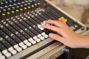 right asian hand adjust audio mixer